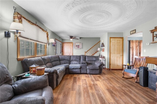 living room featuring hardwood / wood-style floors and ceiling fan