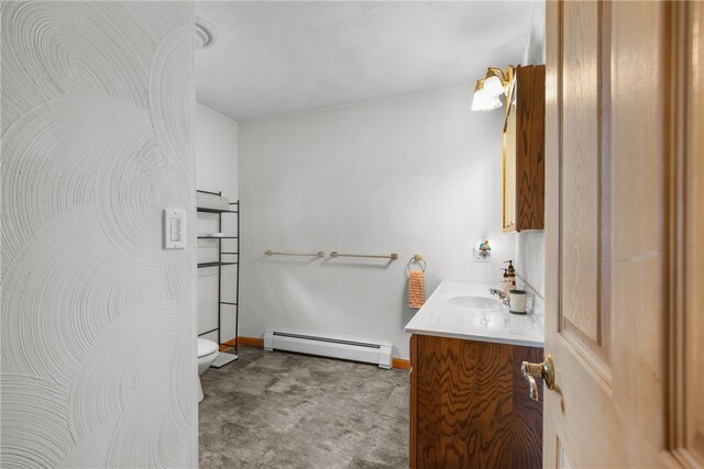 bathroom with vanity, toilet, and a baseboard radiator