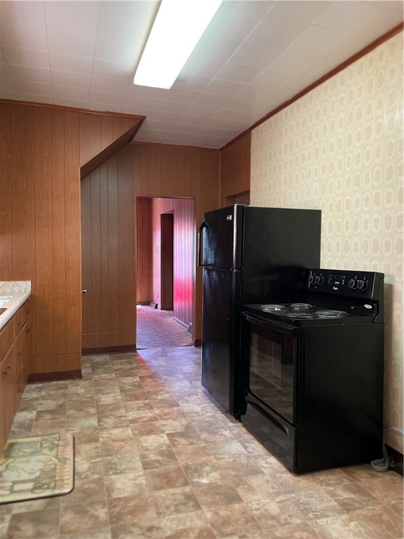 kitchen with wood walls, black range with electric stovetop, and light tile patterned floors