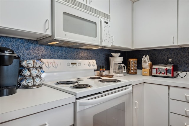 kitchen featuring backsplash, white cabinets, and white appliances