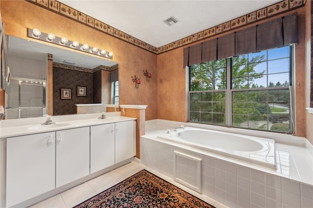 bathroom with tile patterned floors, vanity, and separate shower and tub