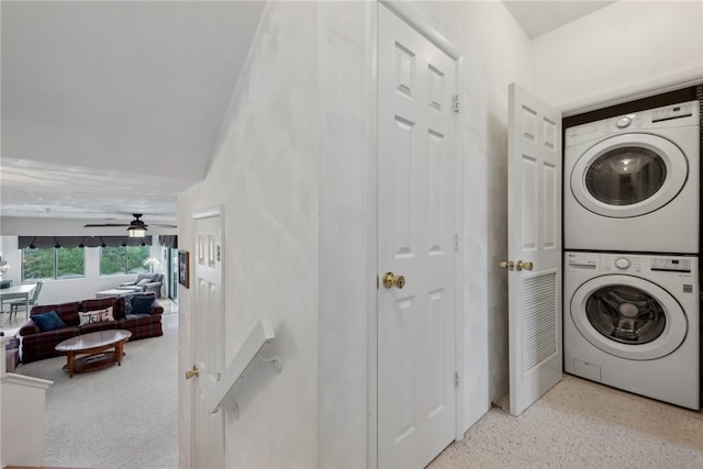 laundry area featuring ceiling fan and stacked washer and clothes dryer