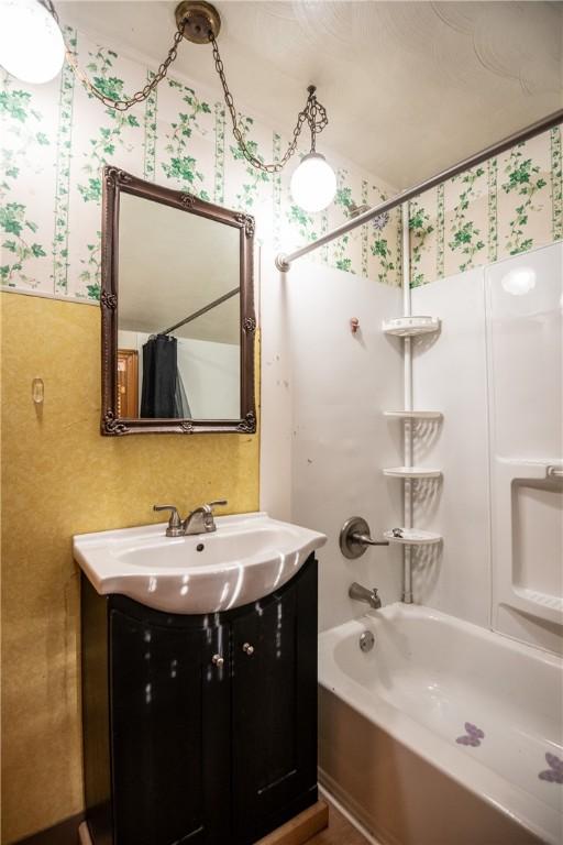 bathroom featuring shower / bath combo and vanity