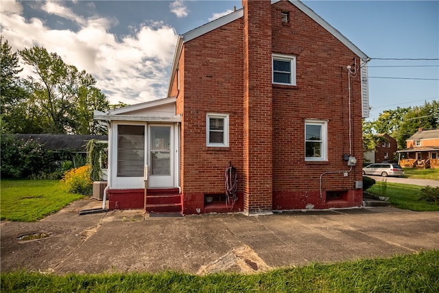 rear view of property with central AC