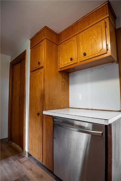 kitchen featuring stainless steel dishwasher and hardwood / wood-style floors