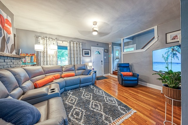 living room featuring ceiling fan and hardwood / wood-style floors