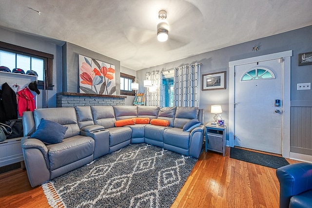 living room with hardwood / wood-style flooring and ceiling fan