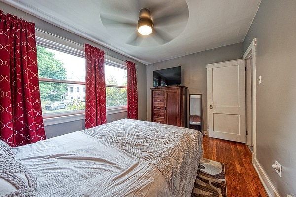 bedroom featuring ceiling fan and dark hardwood / wood-style floors