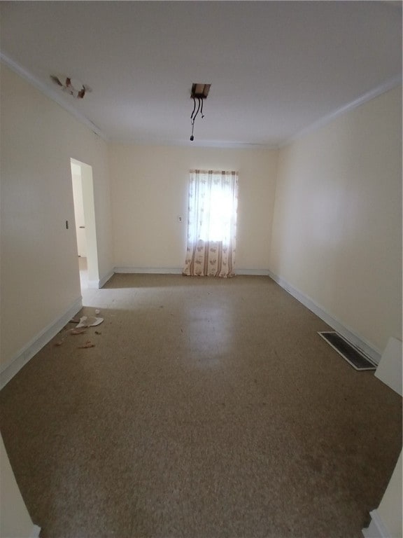 spare room featuring crown molding