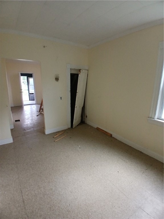 unfurnished room featuring crown molding