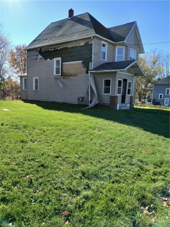 back of house with a lawn