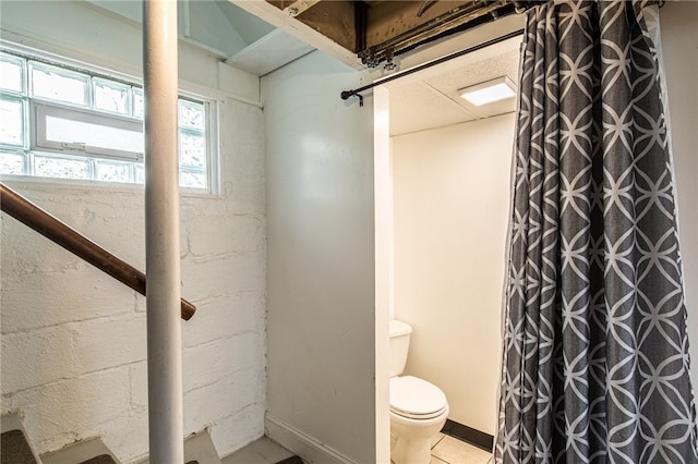 bathroom featuring tile patterned flooring and toilet