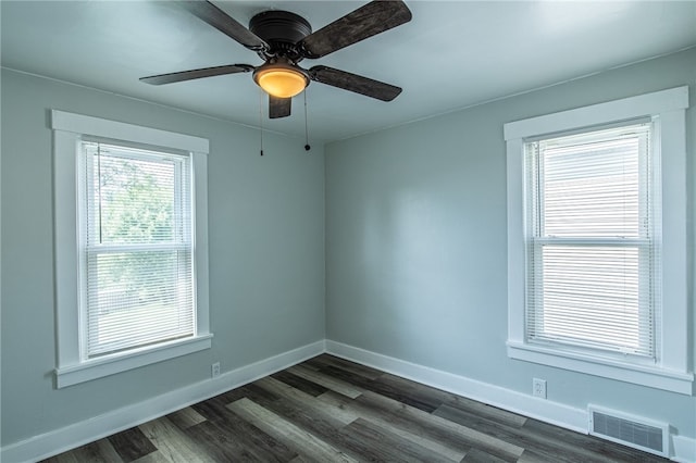 unfurnished room featuring ceiling fan and dark wood-type flooring