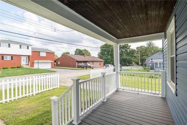 wooden deck with a garage and a yard