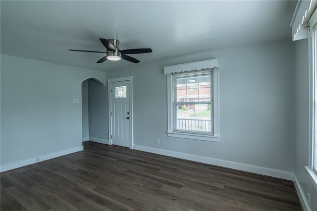 unfurnished room with ceiling fan and dark hardwood / wood-style floors