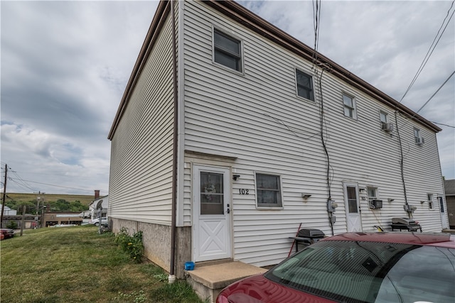 view of side of home featuring a yard