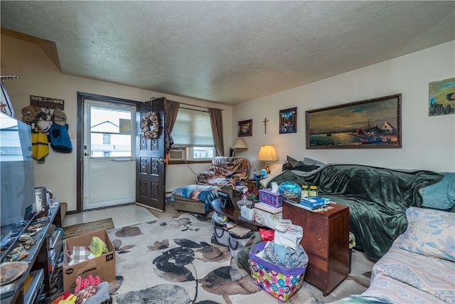 living room with a textured ceiling and light tile patterned floors