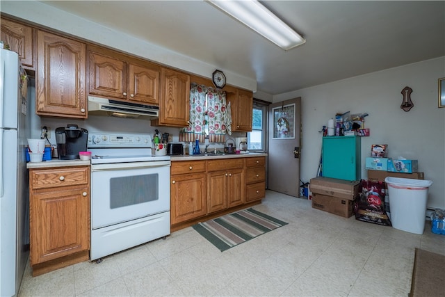 kitchen featuring range hood, white appliances, and light tile patterned floors