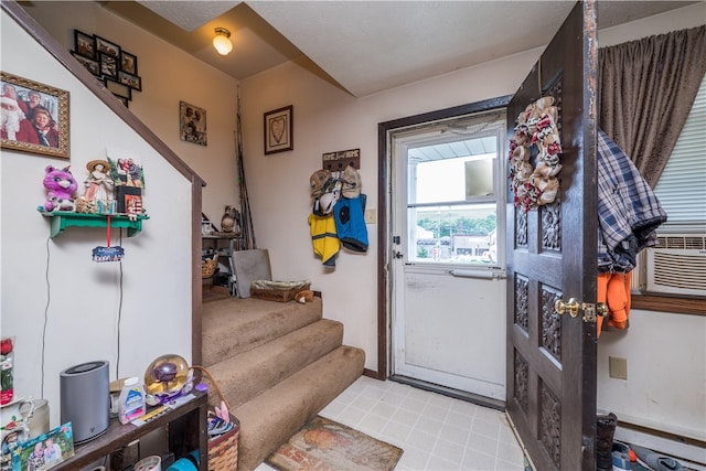 doorway to outside featuring light tile patterned flooring and cooling unit