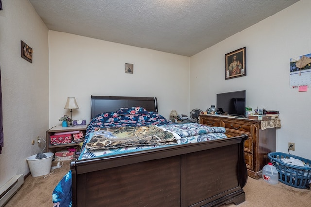 bedroom with a baseboard heating unit, a textured ceiling, and light colored carpet