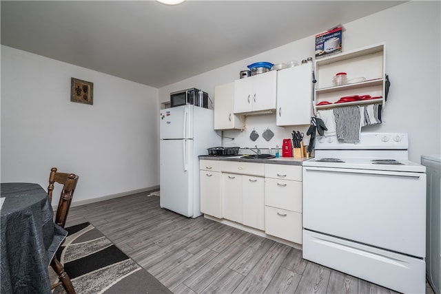 kitchen with light hardwood / wood-style flooring, white cabinets, white appliances, and sink