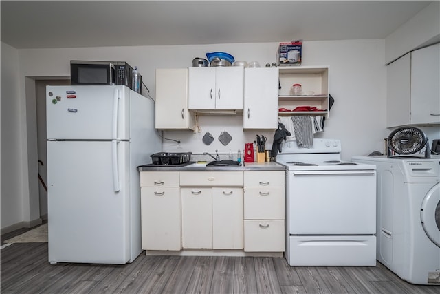 kitchen featuring white cabinets, washer / dryer, light hardwood / wood-style flooring, and white appliances