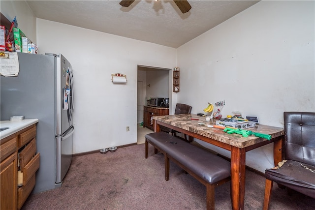 carpeted dining area with ceiling fan