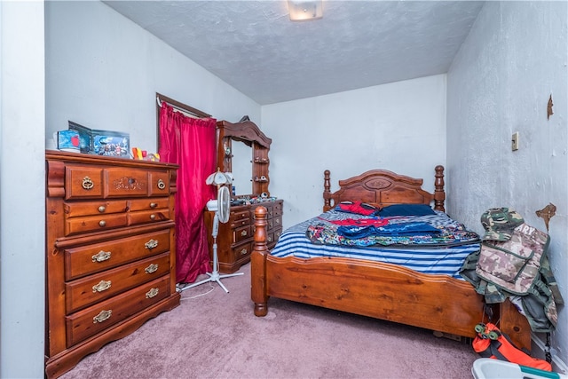 bedroom featuring a textured ceiling and light carpet