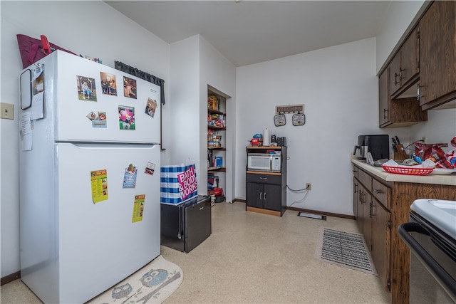 kitchen with white appliances and dark brown cabinetry