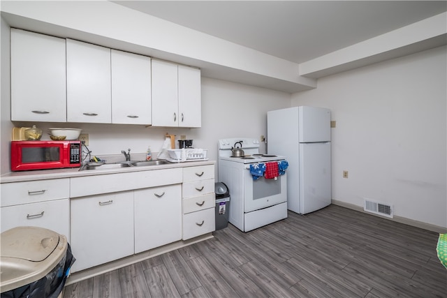 kitchen with white appliances, sink, hardwood / wood-style flooring, and white cabinetry