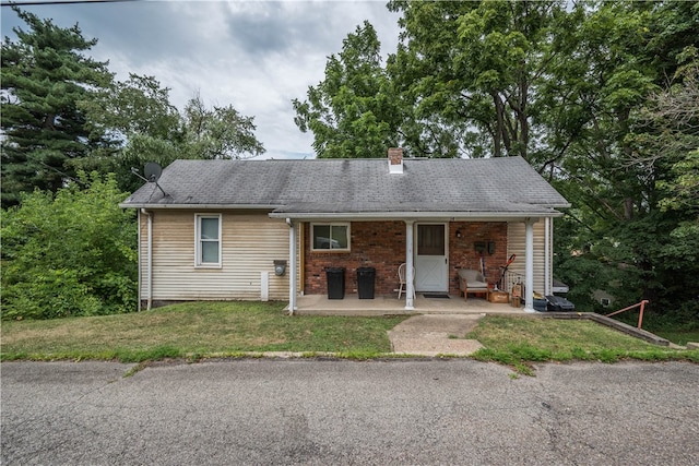 exterior space with covered porch and a lawn