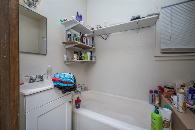 bathroom with vanity and a tub to relax in