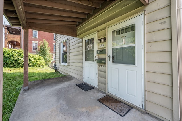 view of exterior entry with a yard