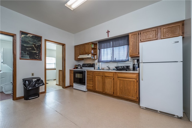 kitchen featuring plenty of natural light, sink, and white appliances