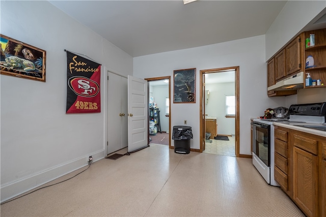 kitchen with light tile patterned flooring and electric range