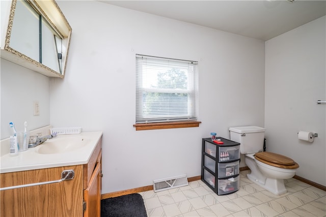 bathroom featuring toilet, tile patterned floors, and vanity