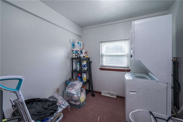 clothes washing area with stacked washer and dryer and carpet flooring