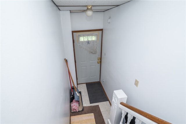 doorway to outside with tile patterned flooring