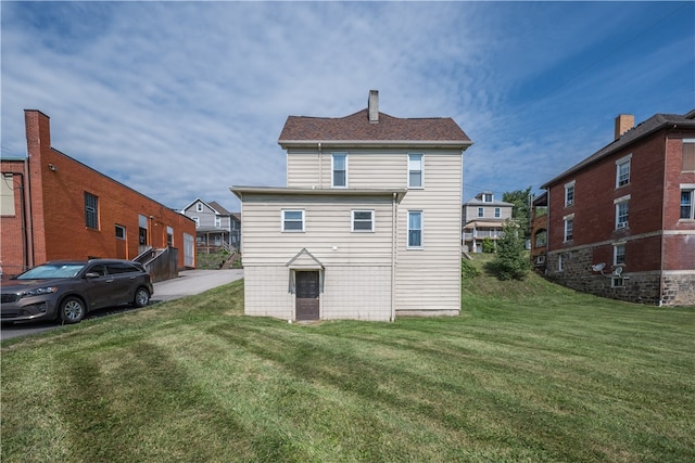 rear view of house with a yard