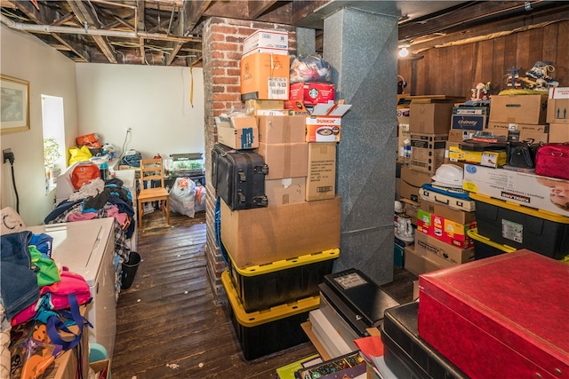 basement with brick wall and hardwood / wood-style floors