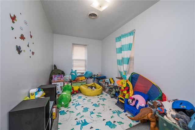 playroom with a textured ceiling