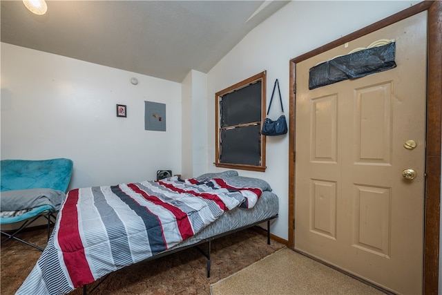 carpeted bedroom featuring lofted ceiling and electric panel