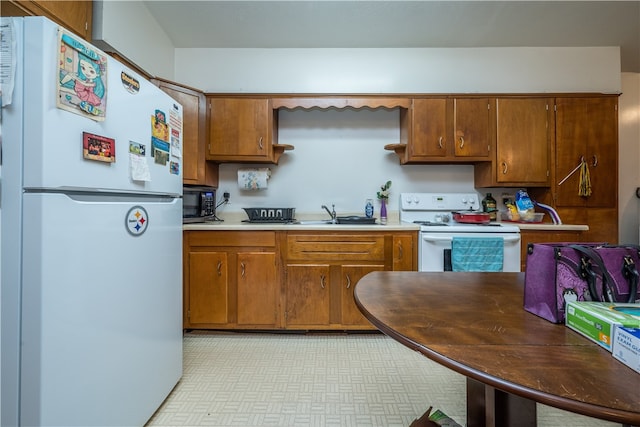 kitchen with white appliances and light tile patterned floors