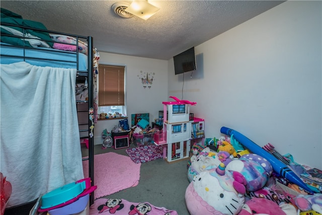 bedroom with a textured ceiling and carpet floors