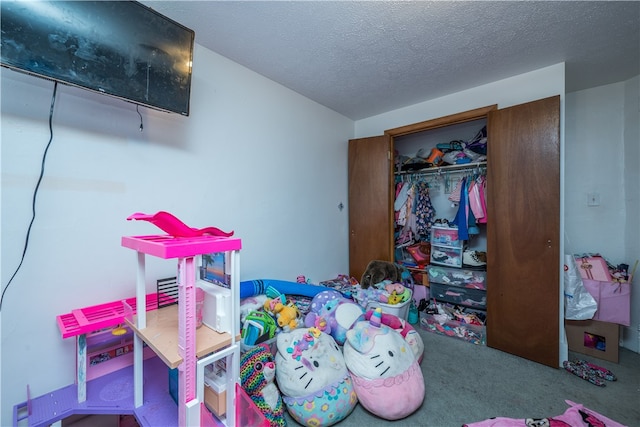 recreation room featuring a textured ceiling and carpet floors