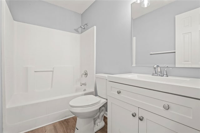 bathroom featuring shower / bathing tub combination, vanity, toilet, and wood finished floors