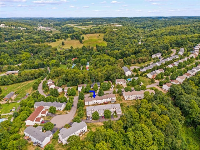 drone / aerial view with a residential view and a view of trees