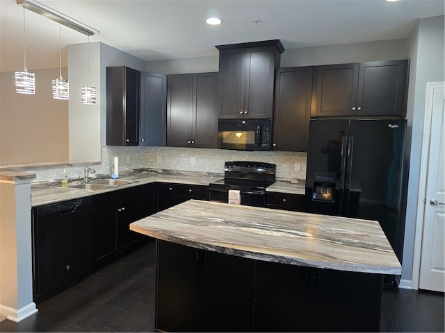 kitchen with dark wood-type flooring, pendant lighting, sink, backsplash, and black appliances