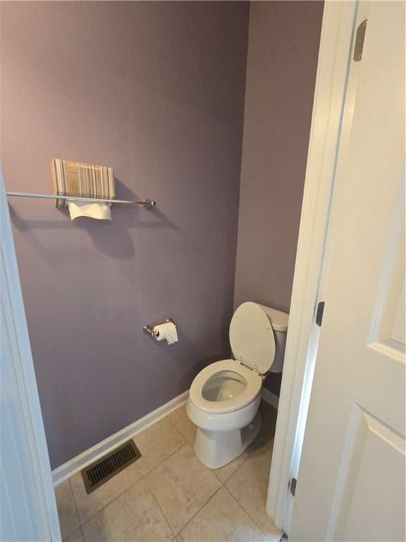 bathroom with toilet and tile patterned floors