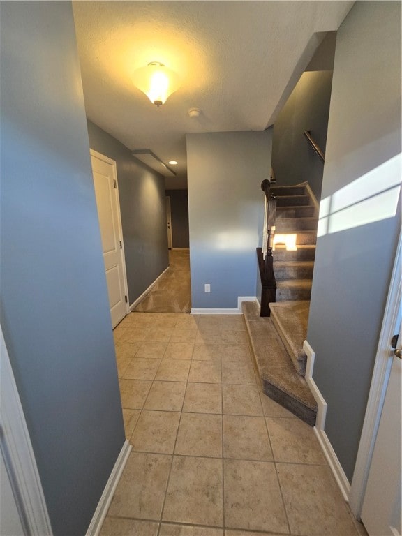 hallway with light tile patterned floors